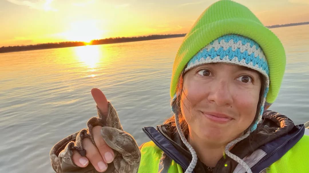 Cory Maria Dack points at the sun