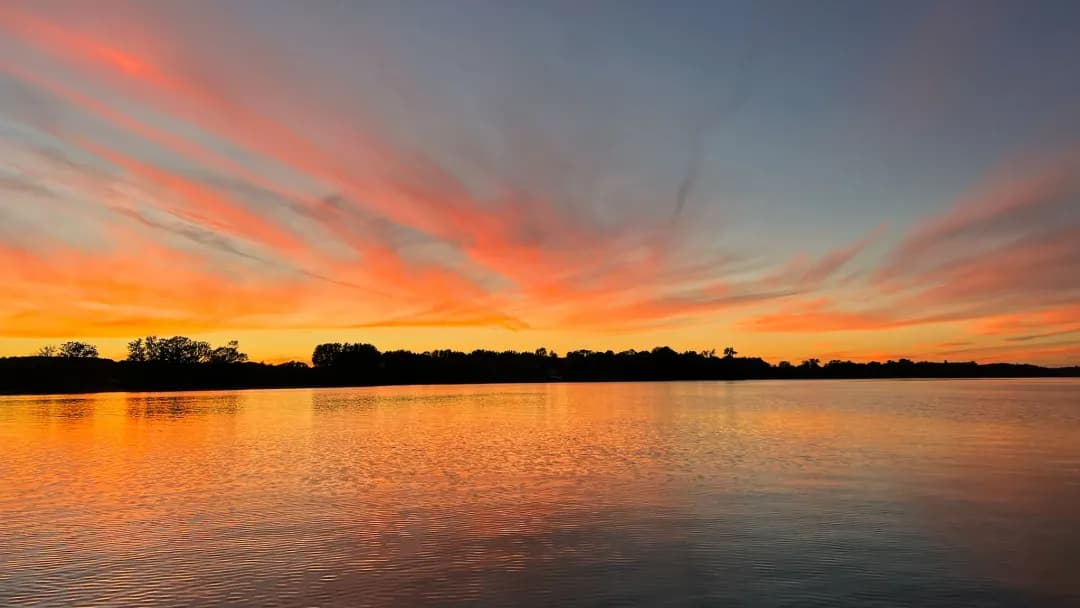 Cory Maria Dack takes a picture of a sunset over the water