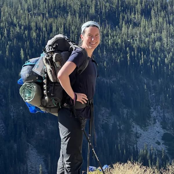 a woman hiking on a mountain