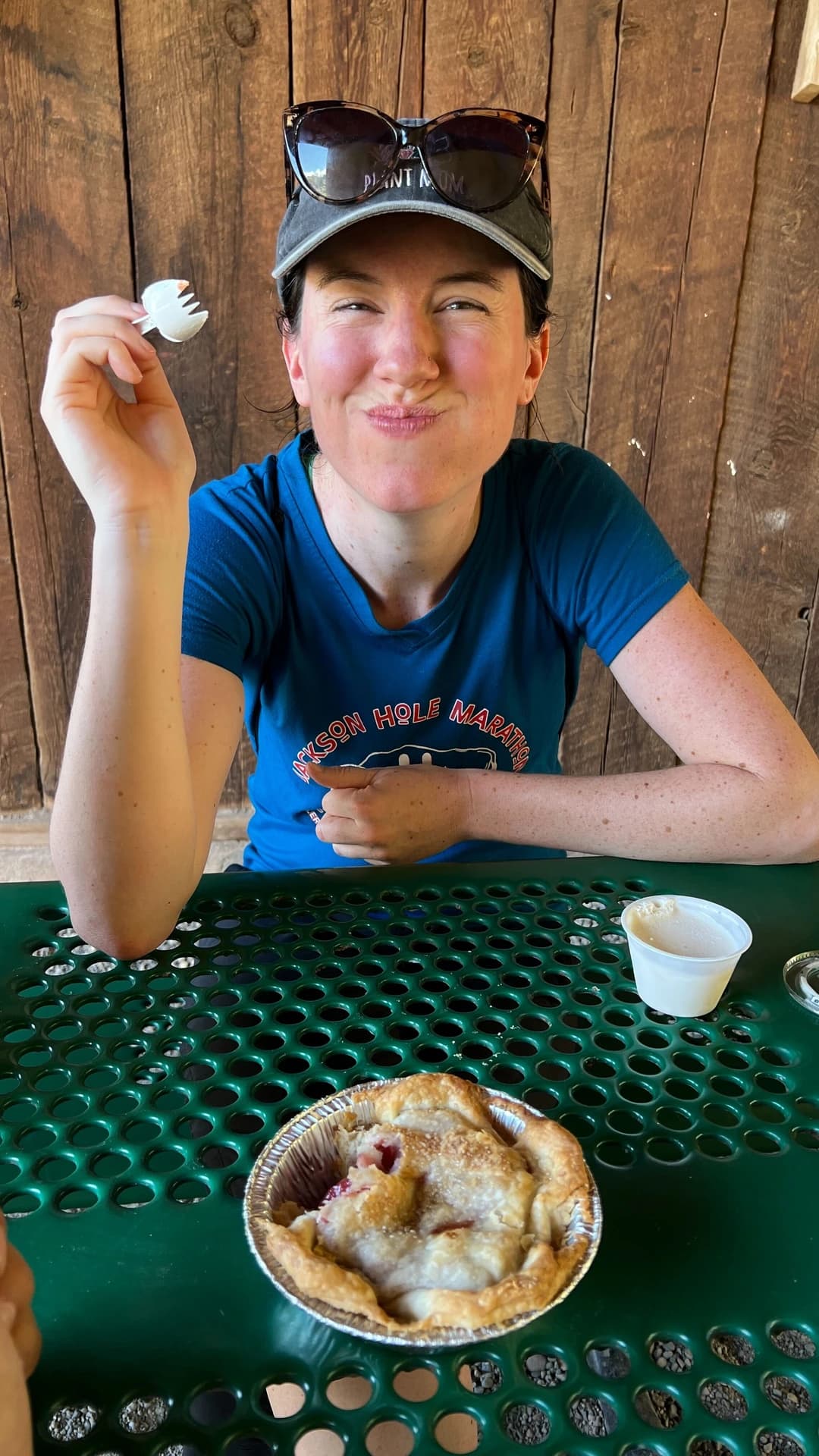 a woman eating a delicious fruit pie