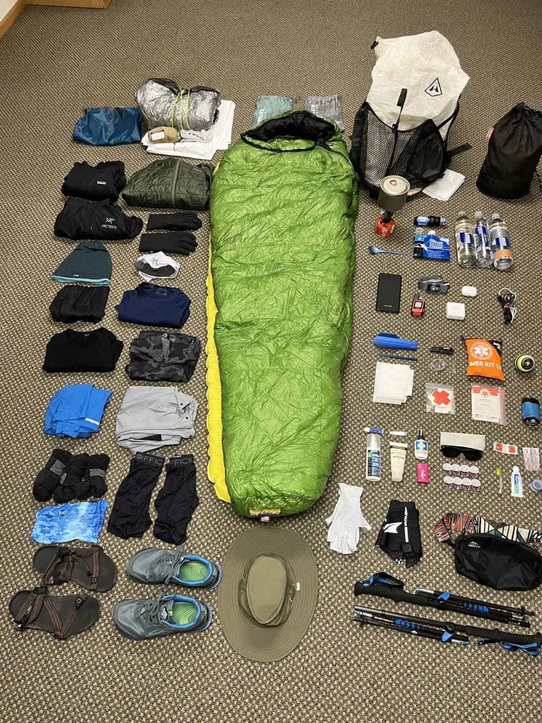 backpacking gear organized on the floor