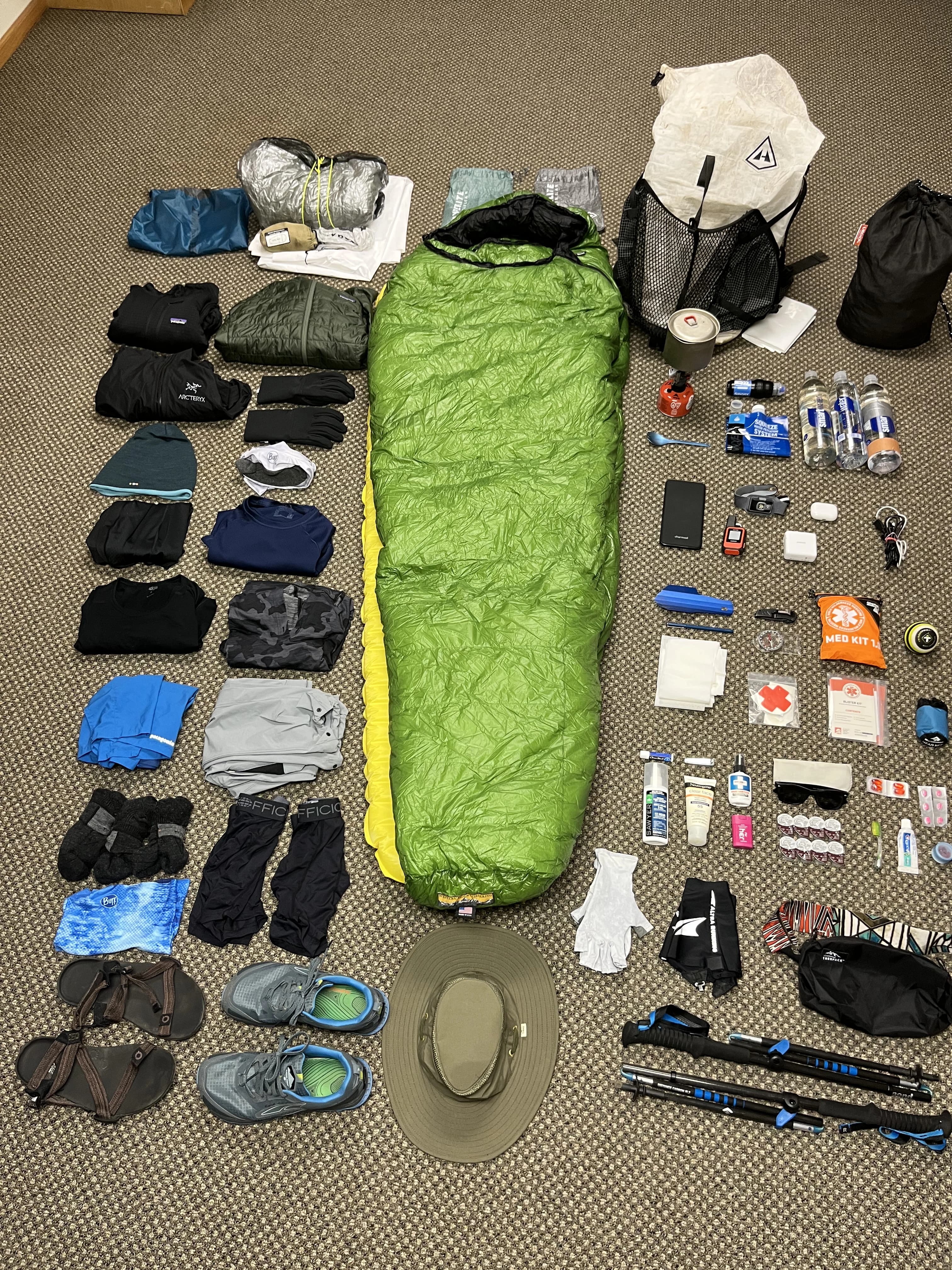 backpacking gear organized on the floor