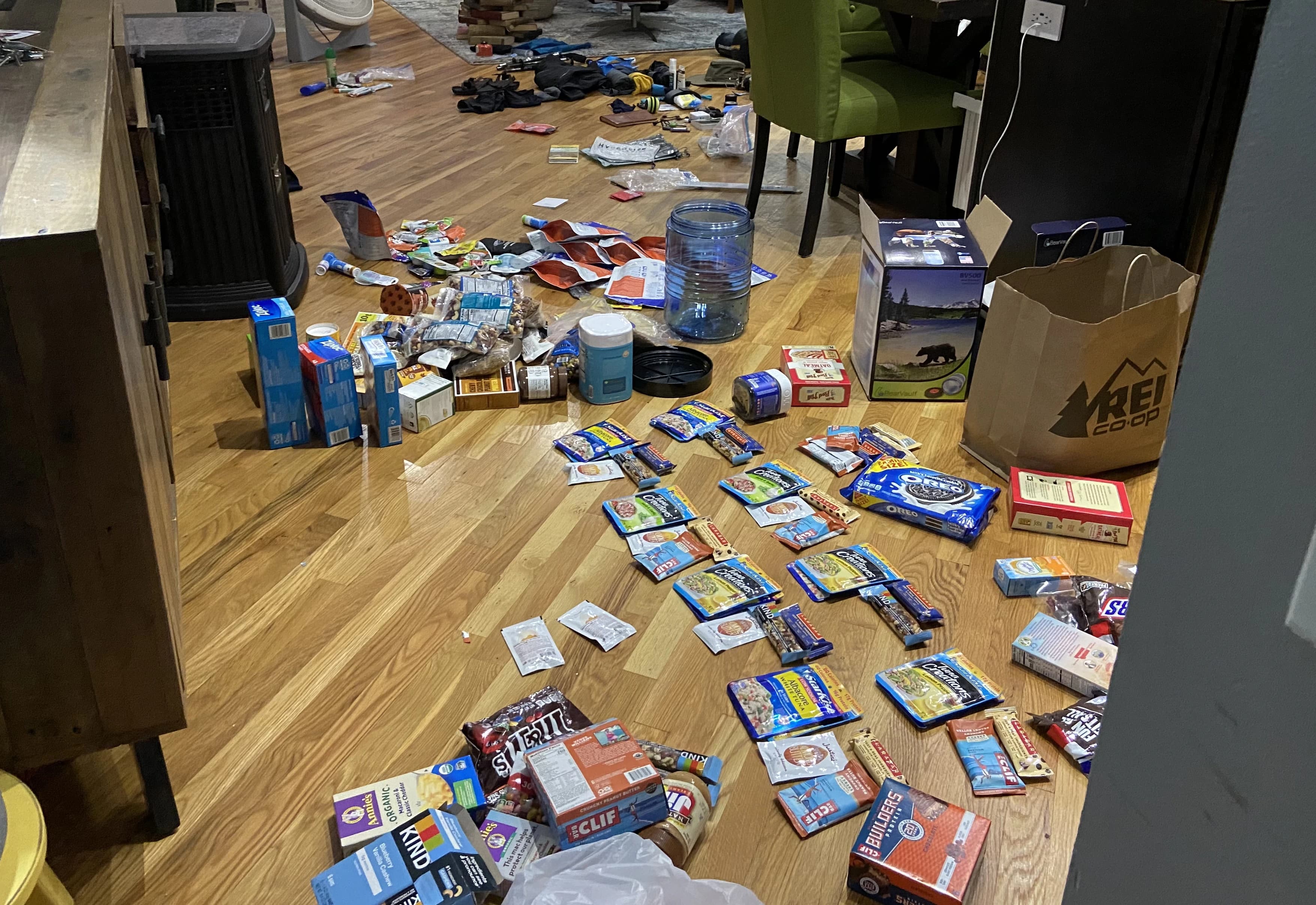 backpacking gear scattered on the floor