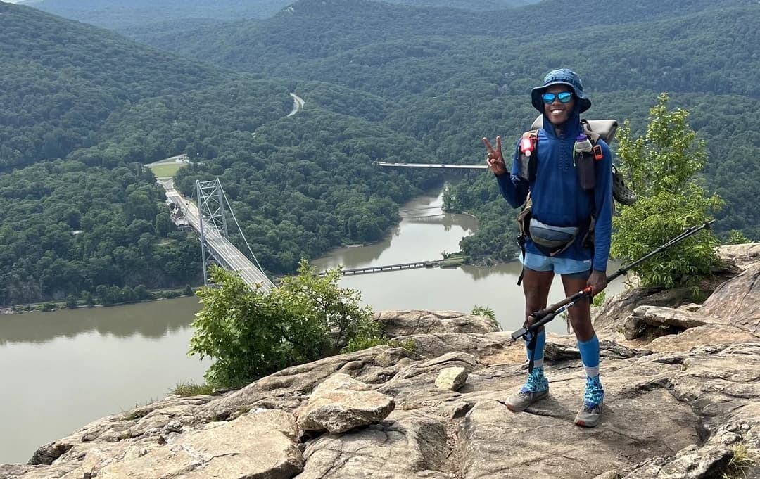 Justin Tucker overlooking a river from a cliff