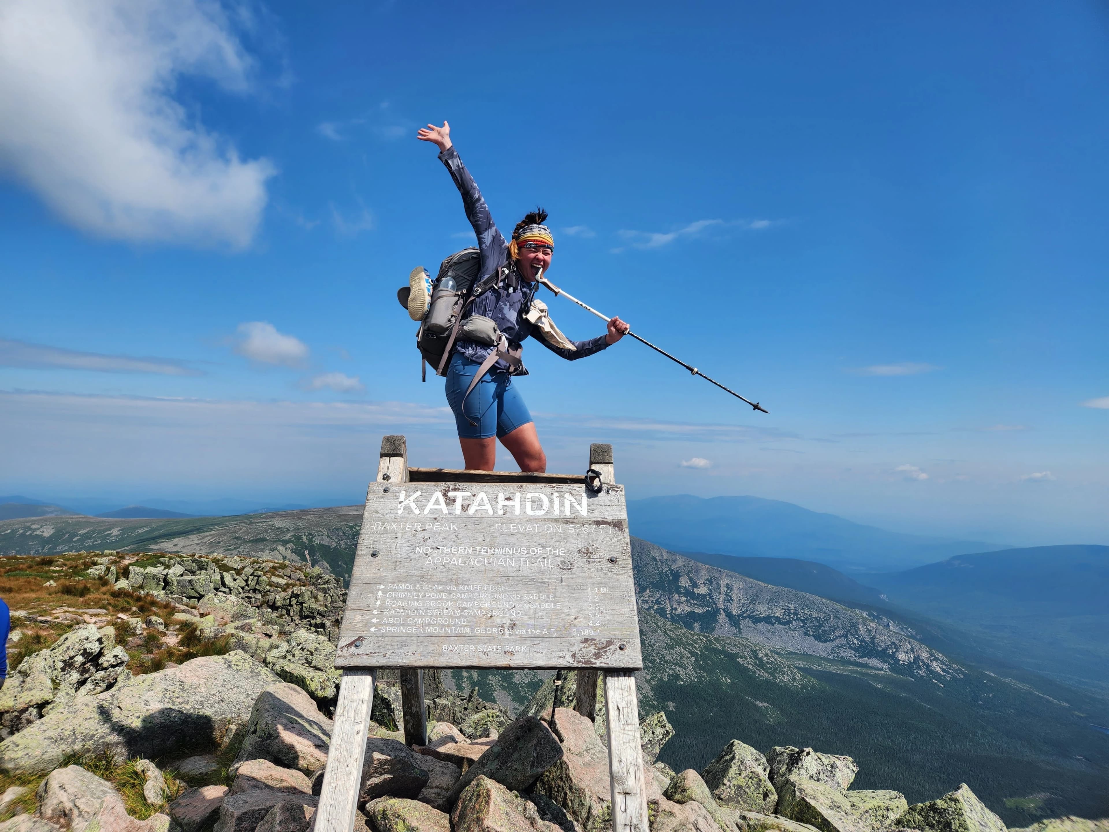 Nicole Kemon standing on the sign for Katahdin