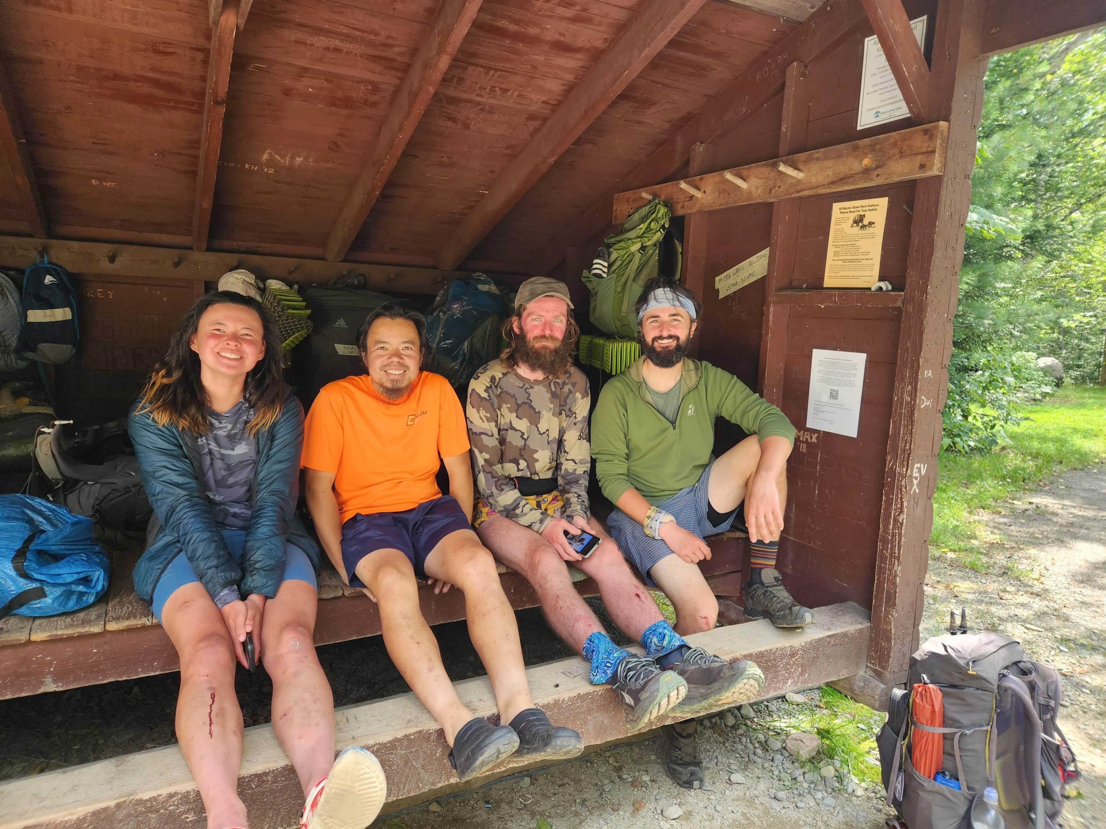 Nicole Kemon under a shelter with friends on the trail