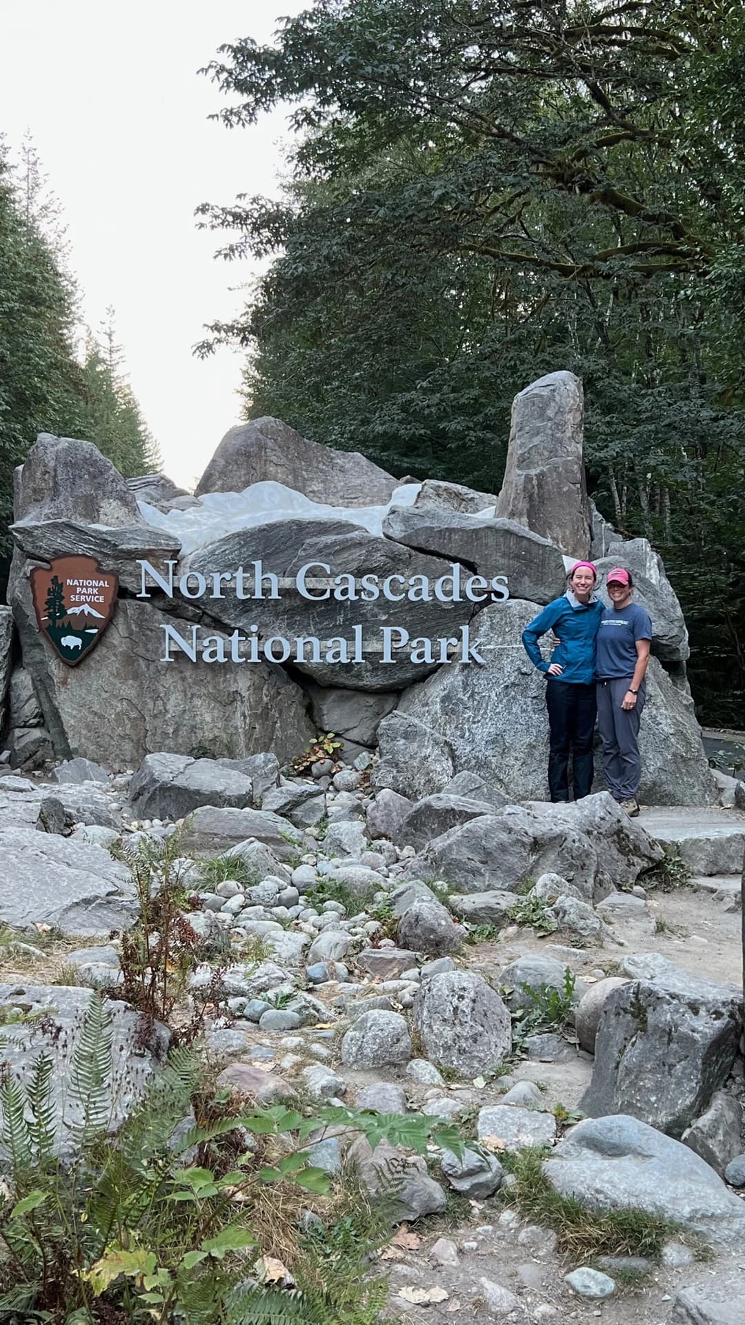 two people in front of the North Cascades National Park sign