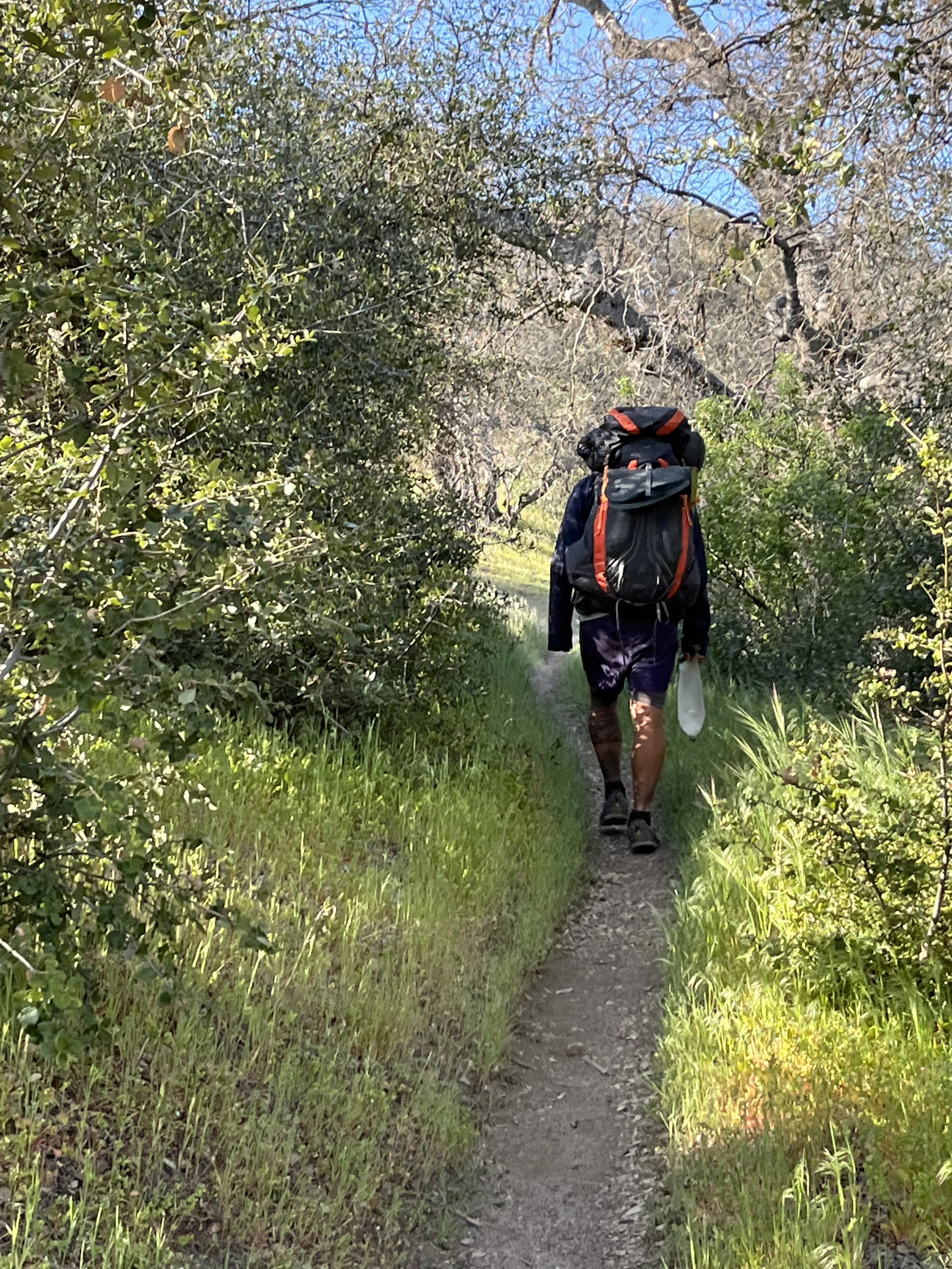 person hiking with a heavy backpack