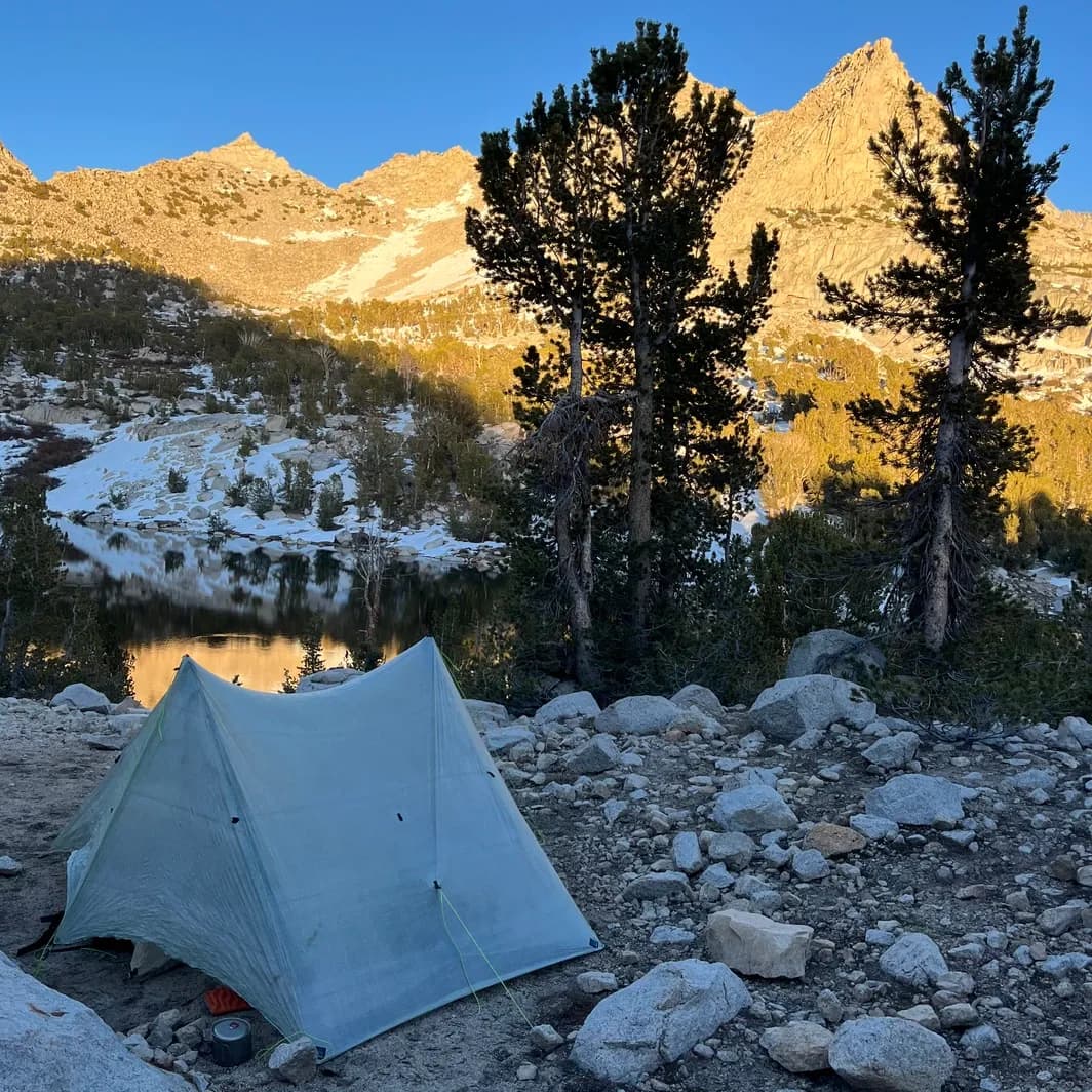 campsite next to a rocky mountain lake