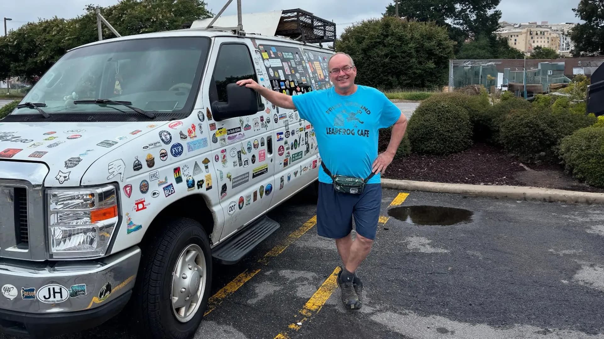 Tim Davis standing by his van at a trailhead