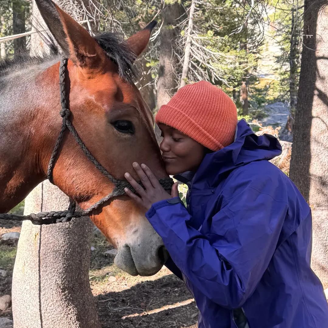 Taneika Duhaney petting a horse